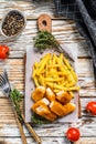 Fried Fish Sticks with French Fries. British fish and chips, fried potato. White wooden background. Top view