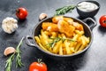 Fried Fish Sticks with French Fries. Fish Fingers. British fish and chips, fried potato. Black background. Top view Royalty Free Stock Photo