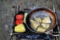 Fried fish, tomatoes and peppers on the grill