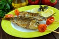 Fried fish (carp) on skewers with pieces pepper Royalty Free Stock Photo