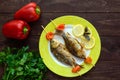 Fried fish (carp) on skewers with pieces pepper and lemon. Royalty Free Stock Photo