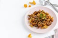 Fried forest chanterelle mushrooms with potatoes. Vegetarian dish on white wooden background