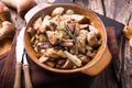 Fried forest mushrooms, boletus, onions. Rustic dish in a frying pan, vegetarian autumn food on top of view
