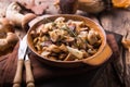 Fried forest mushrooms, boletus, onions. Rustic dish in a frying pan, vegetarian autumn food on top of view