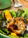 fried fresh shrimp salad with green leaves and mango