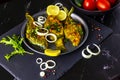 Fried Freshwater Fish with Lemon and Onions in a Plate on Black Slate Board