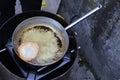 Fried fritter dipped in boiling oil in an aluminum pot Royalty Free Stock Photo