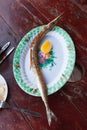Fried garfish in a plate on the table with lemon Royalty Free Stock Photo