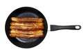 Fried german sausages on a frying pan isolated on white Royalty Free Stock Photo