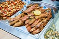 Fried goatfish surmullet with lemon on board. Fried fish gobies in batter with lemon and greens. Roasted fish. Close-up. Royalty Free Stock Photo