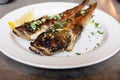 Fried goby fish on plate, close-up