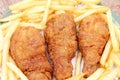 Fried golden chicken legs with french fries