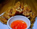 Golden mushroom with chili sauce on plate .