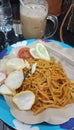 Fried gomak noodles are typical batak food and iced cappuccino coffee