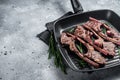 Fried on a grill skillet lamb cutlet steak, mutton rib chop. Gray background. Top view. Copy space Royalty Free Stock Photo