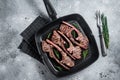 Fried on a grill skillet lamb cutlet steak, mutton rib chop. Gray background. Top view Royalty Free Stock Photo