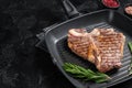 Fried on a grill skillet t bone porterhouse beef meat Steak. Black background. Top view. Copy space