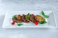 Fried grilled slices of beef fillet with vegetable zucchini and cabbage pancakes Royalty Free Stock Photo