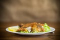 fried hake fish in batter with lettuce and lemon in a plate