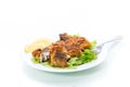 Fried hake fish in batter with lettuce and lemon in a plate