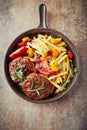 Fried hamburger steaks with tomatoes and french fries. Royalty Free Stock Photo