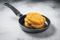 Fried Hash brown potato, hashbrown fritters in a skillet. White background. Top view