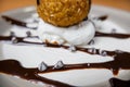 Fried ice cream with chocolate syrup and cream on plate Royalty Free Stock Photo