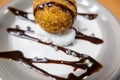 Fried ice cream with chocolate syrup and cream on plate Royalty Free Stock Photo