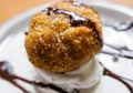 Fried ice cream with chocolate syrup and cream on plate Royalty Free Stock Photo