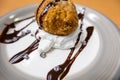 Fried ice cream with cream, chocolate syrup and chips on plate Royalty Free Stock Photo