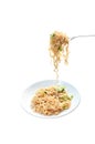 Fried instant noodles with cabbage and egg stabbing in silver fork on plate