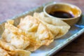 Fried Jiaozi with dipping sauces on wood table background