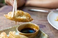 Fried Jiaozi with dipping sauces on wood table background