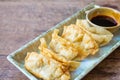 Fried Jiaozi with dipping sauces on wood table background