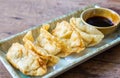 Fried Jiaozi with dipping sauces on wood table