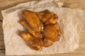 Fried juicy chicken wings marinated with honey, soy sauce and spices on a paper background. Asian recipe, top view, close-up Royalty Free Stock Photo