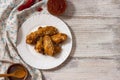 Fried juicy chicken wings marinated with honey, soy sauce, spices, sprinkled with sesame seeds on a white plate with sauce. Asian Royalty Free Stock Photo