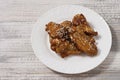 Fried juicy chicken wings marinated with honey, soy sauce, spices, sprinkled with sesame seeds on a white plate on a Royalty Free Stock Photo
