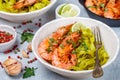 Fried king prawns with garlic, pepper, lime and parsley cilantro. Large shrimp. Langoustine. Delicious dinner with pasta tagliat Royalty Free Stock Photo