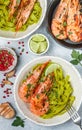 Fried king prawns with garlic, pepper, lime and parsley cilantro. Large shrimp. Langoustine. Delicious dinner with pasta tagliat Royalty Free Stock Photo