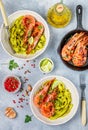 Fried king prawns with garlic, pepper, lime and parsley cilantro. Large shrimp. Langoustine. Delicious dinner with pasta tagliat Royalty Free Stock Photo