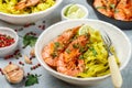 Fried king prawns with garlic, pepper, lime and parsley cilantro. Large shrimp. Langoustine. Delicious dinner with pasta tagliat Royalty Free Stock Photo