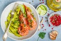 Fried king prawns with garlic, pepper, lime and parsley cilantro. Large shrimp. Langoustine. Delicious dinner with pasta tagliat Royalty Free Stock Photo