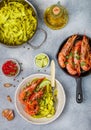 Fried king prawns with garlic, pepper, lime and parsley cilantro. Large shrimp. Langoustine. Delicious dinner with pasta tagliat Royalty Free Stock Photo