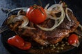 Fried lamb with vegetables. Fried meat on a black background Royalty Free Stock Photo