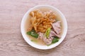 fried large noodle with slice soft marinated pork and Chinese kale dressing gravy sauce on plate