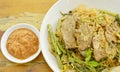 Fried large rice noodles dressing with chicken and vegetable in gravy sauce on plate Royalty Free Stock Photo