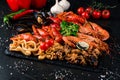 fried large tray appetizer crayfish, squid on black slate Royalty Free Stock Photo