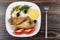 Fried legs with rice, pieces of tomatoes, olives, dill Royalty Free Stock Photo