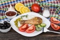 Fried legs, rice, vegetable, lemons, black olives and ketchup Royalty Free Stock Photo